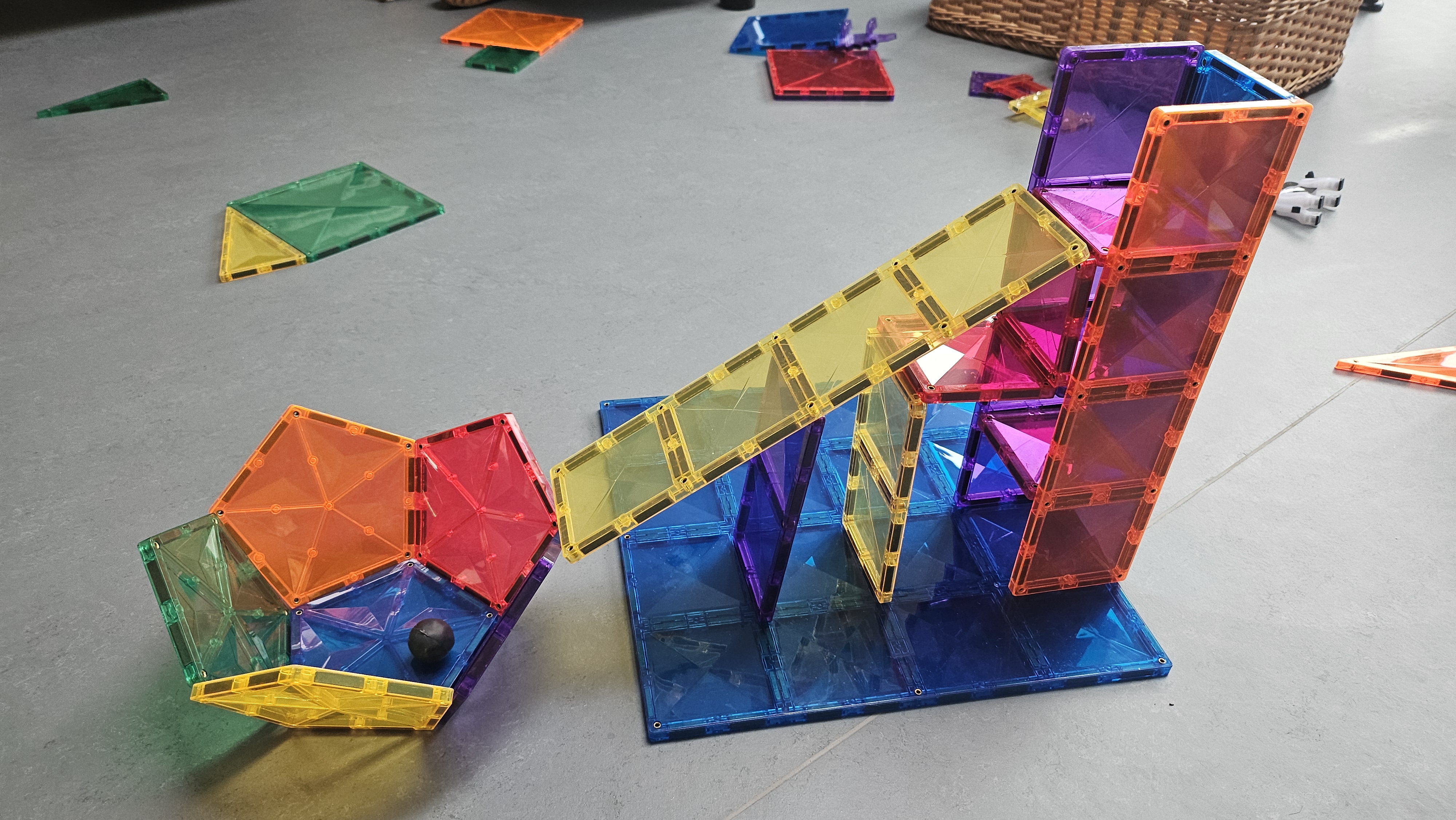 Connetix marble run and magnetic builds on the floor