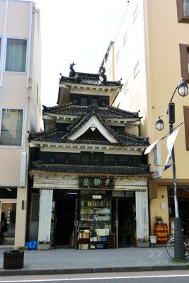 Old house between new buildings in Matsumoto, Japan
